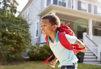 Child running with backpack