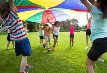 kids playing under big tent