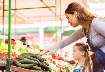 woman and child selecting produce at market