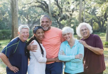 A group of seniors standing together while smiling at the camera.