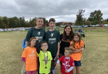 Josh Dettinger, a Y volunteer, and his family. 