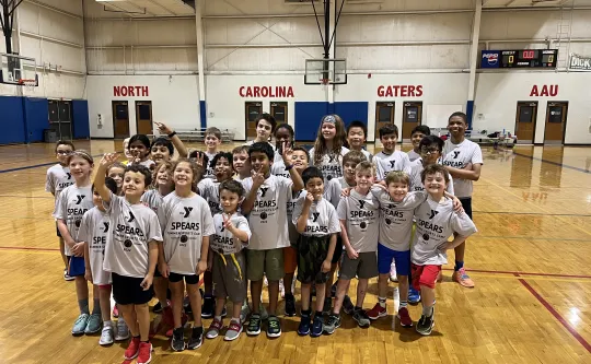 A photo of a diverse group of children at a Spears YMCA basketball camp.