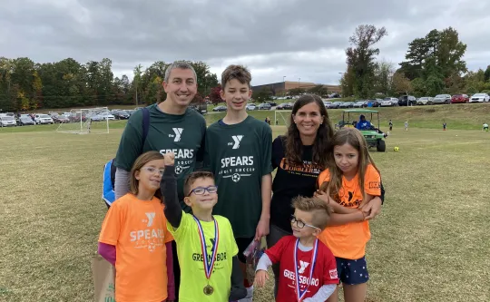 Josh Dettinger, a Y volunteer, and his family. 