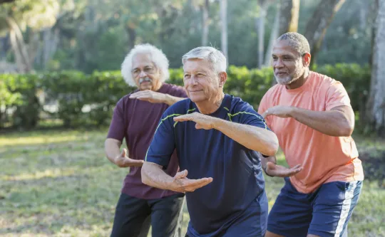 A group of adults in a Tai Chi class.