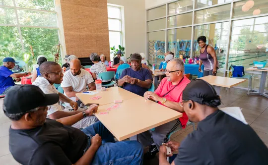 Group of men at table playing cards at the Hayes-Taylor Memorial YMCA