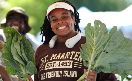 Woman with vegetables at health fair in greensboro
