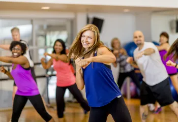 A woman in a group exercise class.