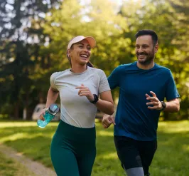 Two friends running outdoors.