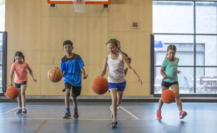 kids dribbling basketballs