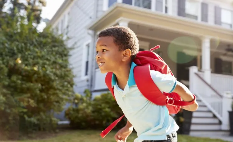 Child running with backpack