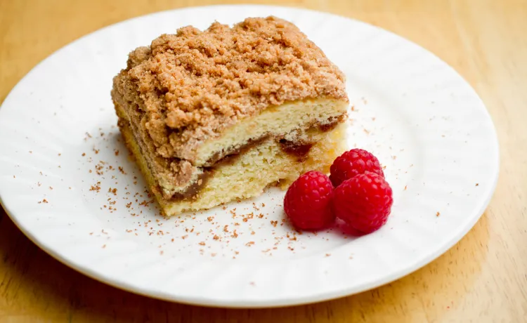 coffee cake on plate with raspberries