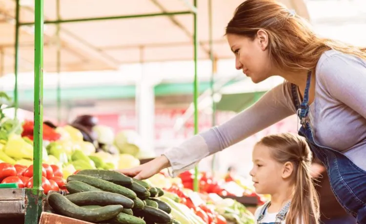 woman and child selecting produce at market