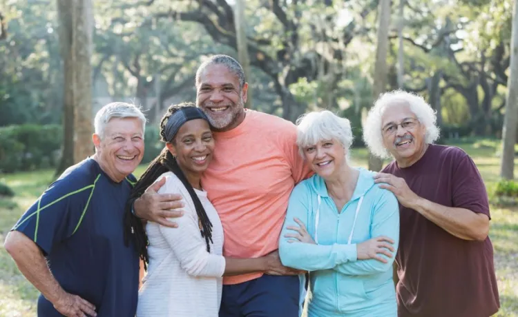 A group of seniors standing together while smiling at the camera.