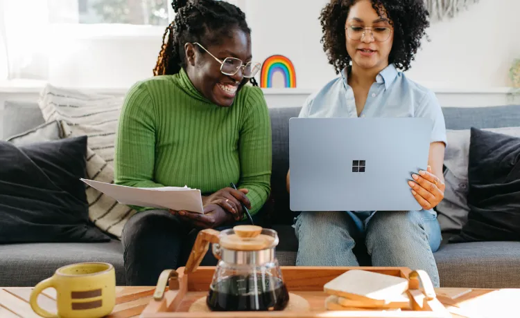 Two females looking at a computer. 