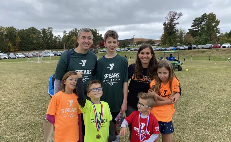 Josh Dettinger, a Y volunteer, and his family. 