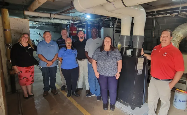 Weil-McLain and Eden Family Y staff in front of new boiler. 