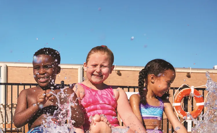 A group of children at the edge of a pool during a Safety Around Water class.