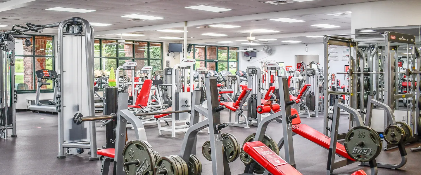 A photo of the Stoney Creek YMCA's fitness room. There are various exercise machines and weight lifting machines.