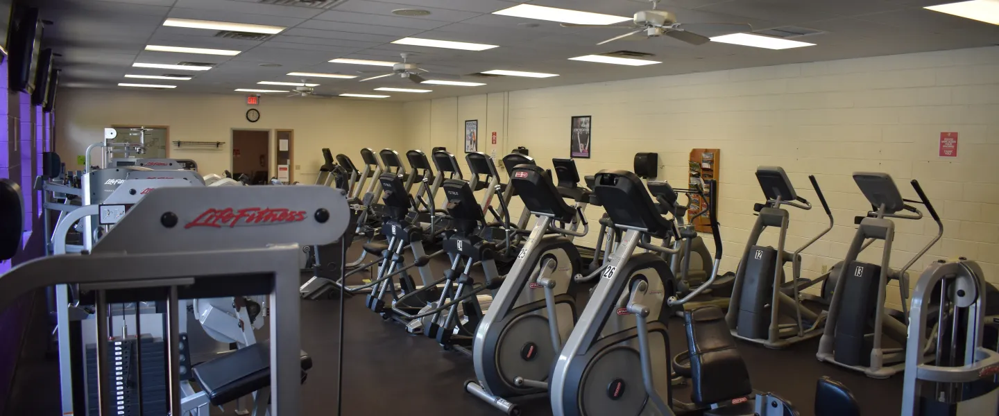 A photo of the Reidsville YMCA's fitness area. There are rows of exercise machines like stationary bikes.