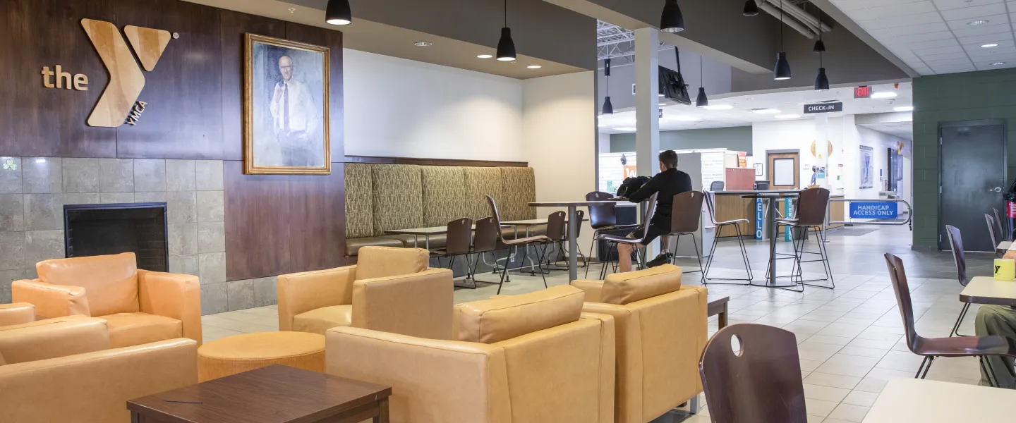 A photo of the lobby at the Spears YMCA. There are tan couches and assorted tables.