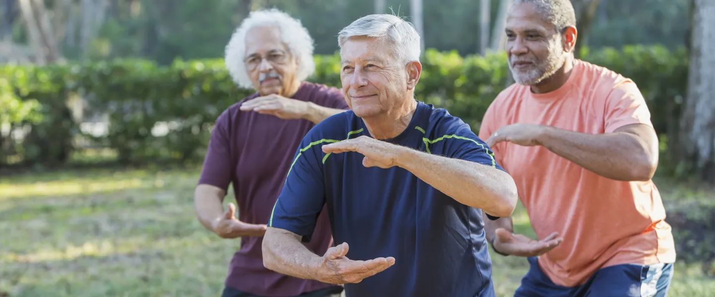 A group of adults in a Tai Chi class.