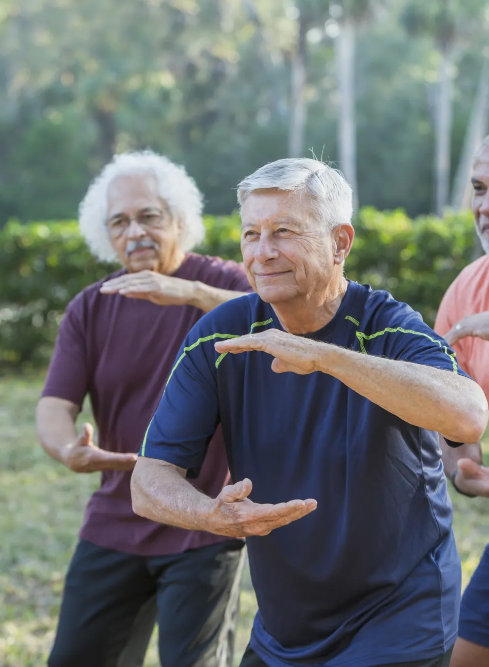 A group of adults in a Tai Chi class.