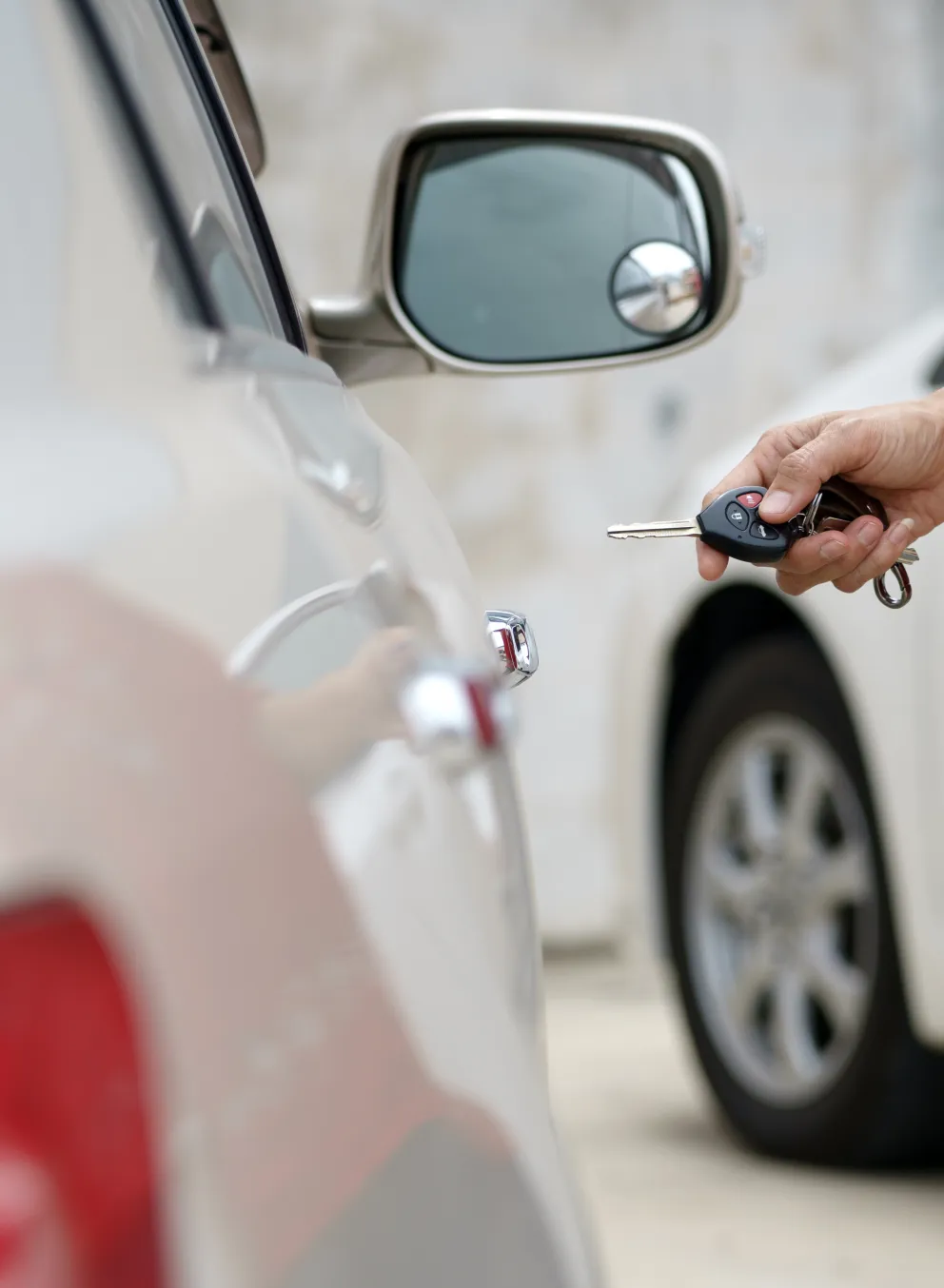 Person unlocking car with key.