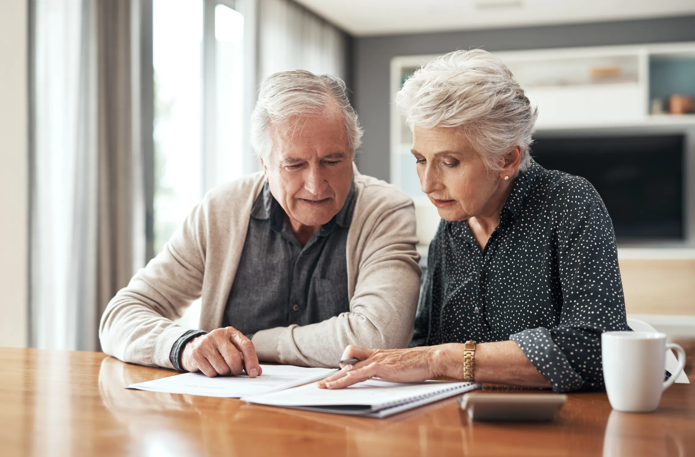 A senior couple looks at a document together.