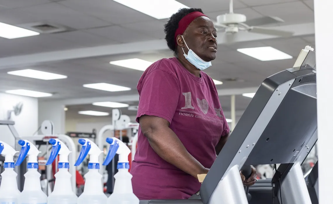 A woman working out at the Stoney Creek YMCA. She is using a treadmill.