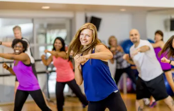 A woman in a group exercise class.