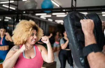 Woman in self defense class in gym