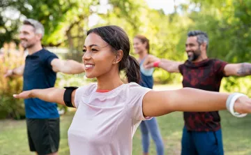 A group of people in an outdoor fitness class.