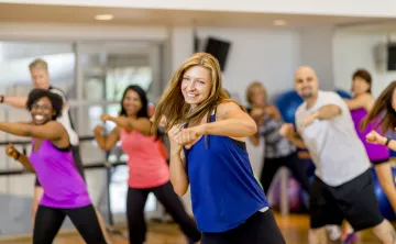 A woman in a group exercise class.